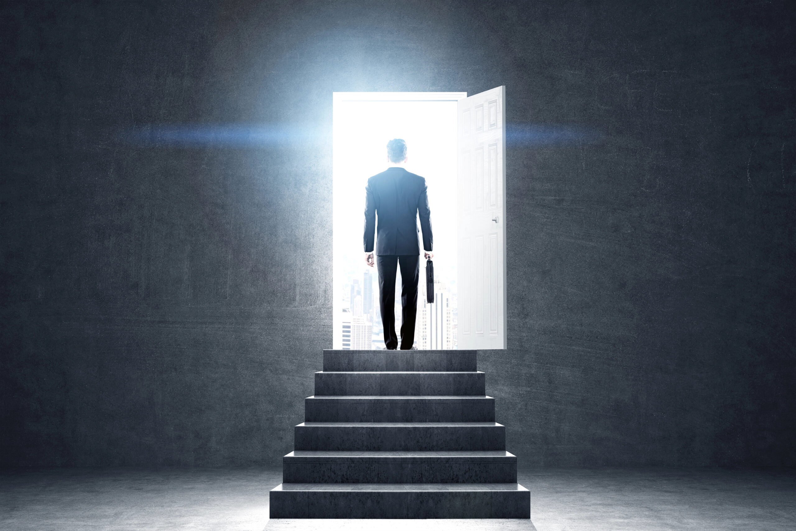 PathForward™: man standing at the top of steps in brightly lit doorway.
